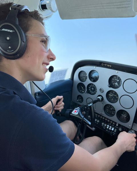 young man in airplane cockpit.