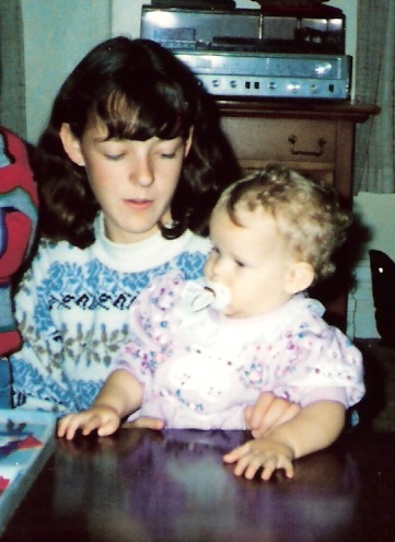 Photo of artist Kelly Stevenson being held by her older cousin Sarah